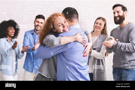 Positive happy people hugging each other at rehab group meeting ...