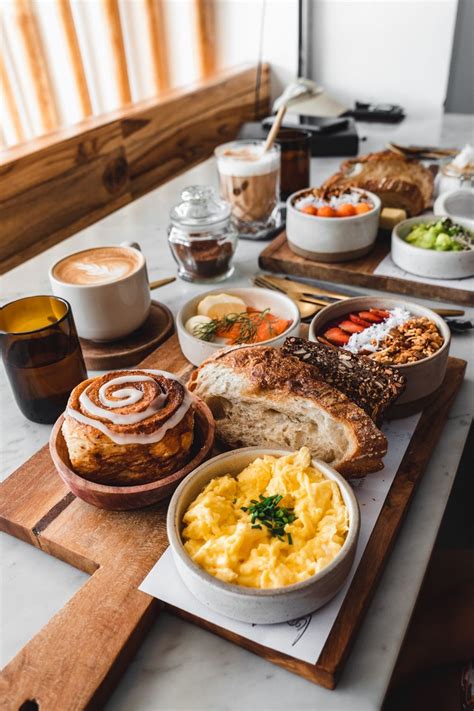 an assortment of breakfast foods on a wooden tray