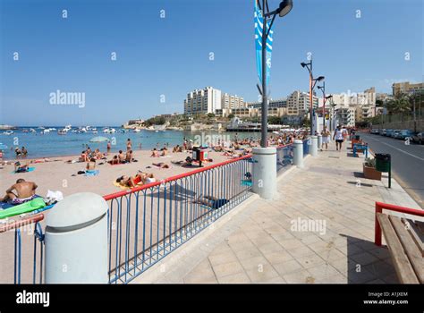 Beach and seafront promenade at St George's Bay, Malta Stock Photo - Alamy