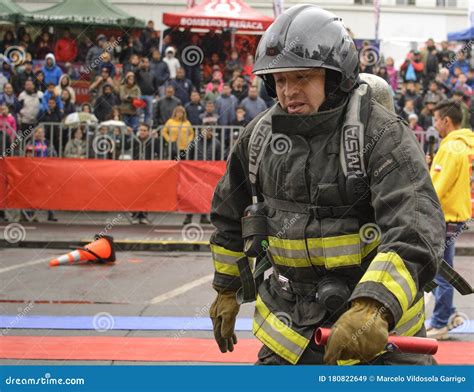 A Firefighter In Uniform And Helmet Uses Foam . Editorial Photo | CartoonDealer.com #233808367