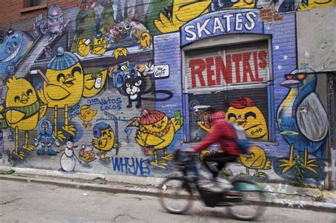 A Man Riding a Bicycle with a Graffiti Background Editorial Stock Image - Image of commuter ...