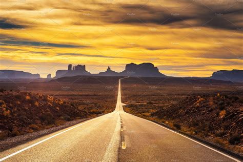 Desert road leading to monument valley at sunset stock photo containing | Nature Stock Photos ...