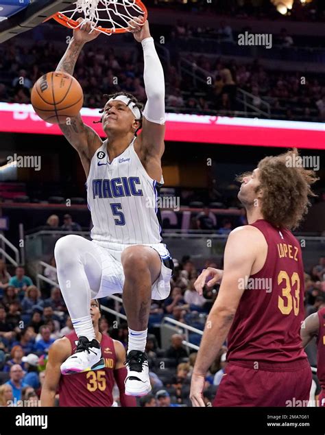 Orlando Magic's Paolo Banchero (5) dunks over Cleveland Cavaliers' Robin Lopez (33) during the ...