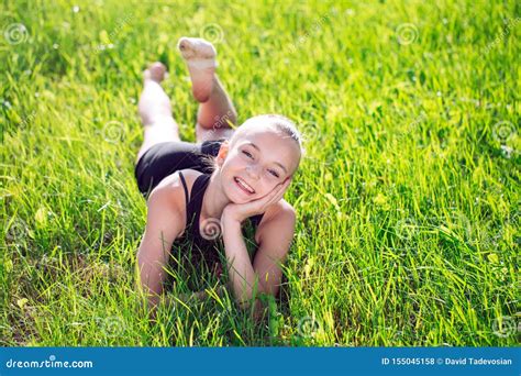 Cute Happy Little Girl Lying on the Grass. Stock Photo - Image of caucasian, lawn: 155045158