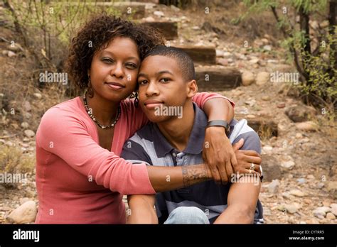 Loving single-mother hugging her handsome teenage son Stock Photo - Alamy