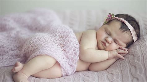 cute baby girl is sleeping on bed covered with netted cloth and having band on head hd cute ...