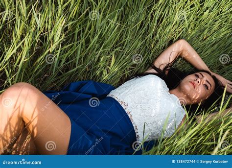 Beautiful Girl Lying Down at Grass Stock Photo - Image of beautiful, carefree: 138472744