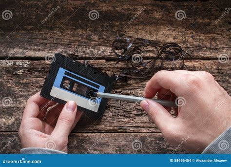 Man rewind a cassette tape stock photo. Image of record - 58666454