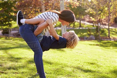 Loving mother hugging son in park - Stock Photo - Dissolve