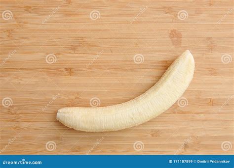 A Peeled Banana without Peel Lies on a Wooden Cutting Board Stock Image - Image of closeup ...