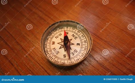 Magnetic Compass Indicating North Closeup Shot on a Wooden Background Stock Image - Image of ...