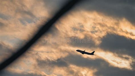 Silhouette of an Airplane Flying in the Cloudy Sky at Sunset Stock Image - Image of outdoors ...