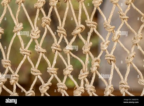 Close up of the knots on a traditional fishing net made by knotting ropes together Stock Photo ...