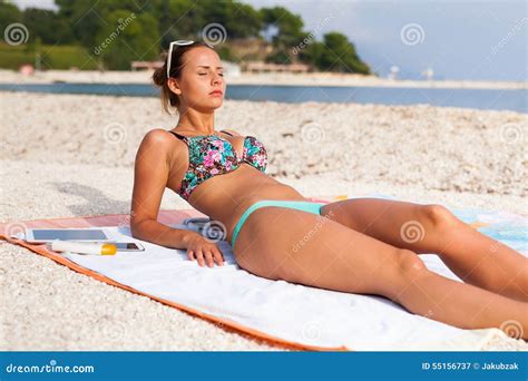 Pretty Girl Lying on the Beach and Sunbathing Stock Image - Image of lying, attractive: 55156737