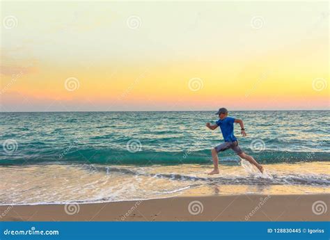 Boy Running Along the Beach at Sunset Stock Image - Image of caucasian ...