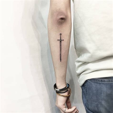 Little black sword tattoo on the back of the left forearm #Tattoosonback | Sword tattoo, Tricep ...