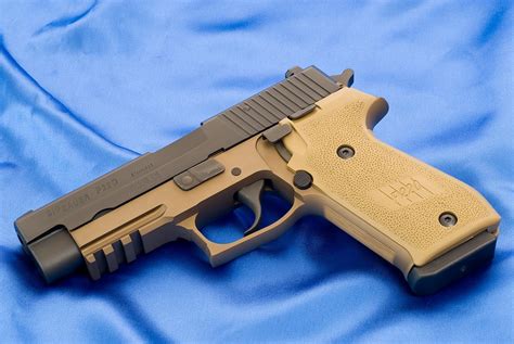 Weapons: Sig-Sauer P220 Combat chambered in .45 Auto, wearing the ...