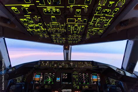 Beautiful twilight sunset sky at high altitude from airplane cockpit view. Inside cockpit can ...