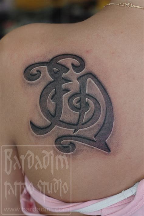 Engraved monogram tattoo by George Bardadim: TattooNOW