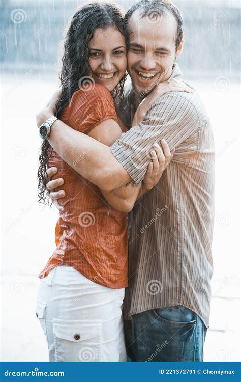 Couple hugging in the rain stock image. Image of happy - 221372791