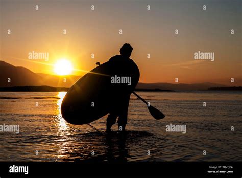 Paddle boarding sunsets Stock Photo - Alamy