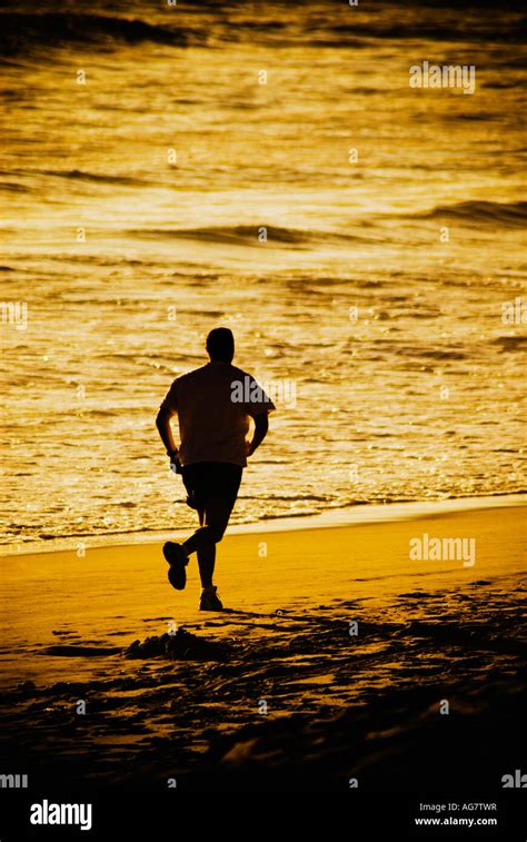 Silhouette of man running on beach Stock Photo - Alamy