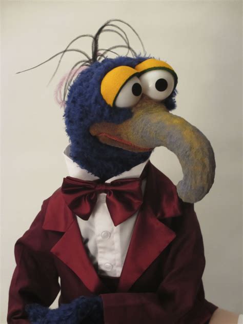 a stuffed bird wearing a tuxedo and bow tie