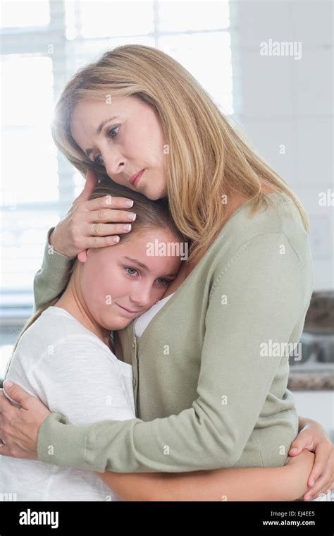 Mother hugging daughter sad hi-res stock photography and images - Alamy