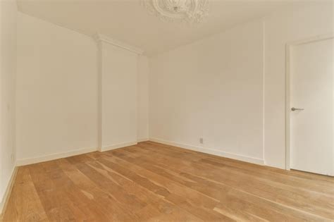 Premium Photo | An empty room with white walls and wood floors