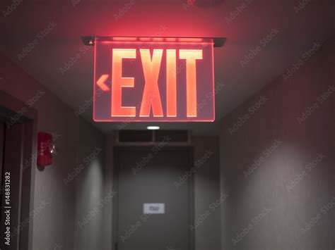 Glowing red exit sign. Stock Photo | Adobe Stock