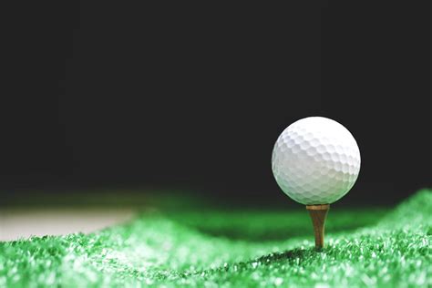 Close-up of golf ball on tee at night 1920208 Stock Photo at Vecteezy