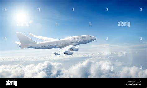 Airplane flying above clouds Stock Photo - Alamy