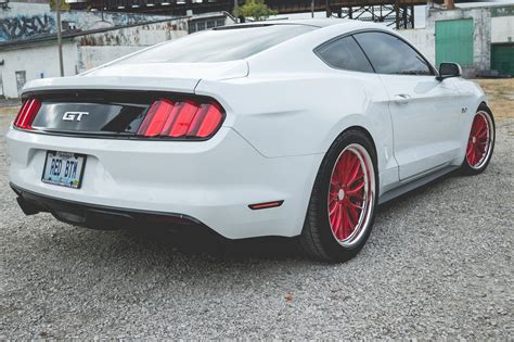 Striking Contrast: Custom Red Vossen Wheels on White Ford Mustang — CARiD.com Gallery