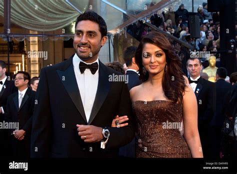 Indian actress Aishwarya Rai Bachchan (R) and her husband Abhishek ...