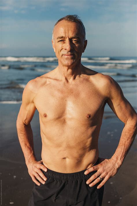 "Active Senior Man - In Great Shape - Standing Shirtless On Beach In Morning Sunshine" by ...