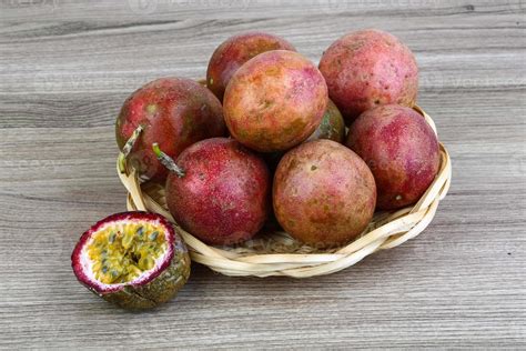 Fresh tropical fruit - Maracuja in a basket on wooden background 8895226 Stock Photo at Vecteezy