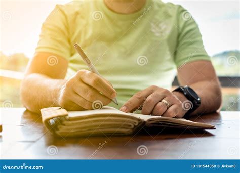 A Young Successful Person Taking Notes in a Personal Journal Stock ...