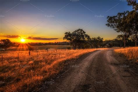 Countryside landscape with rural dirt road at sunset in Australia ~ Nature Photos ~ Creative Market