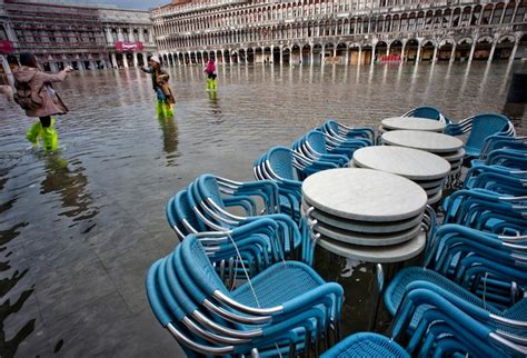 Premium Photo | Blue stacked chairs on water filled walkway during flood at piazza san marco