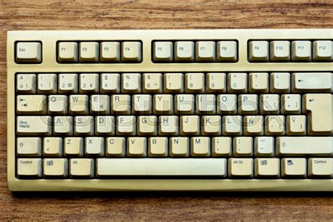 Old keyboard of a computer on a wooden ... | Stock image | Colourbox