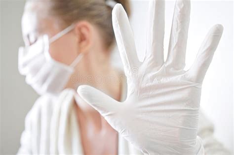 Hand with a Medical Face Mask and Medical Gloves for Protection Against Coronavirus Covid-19 ...