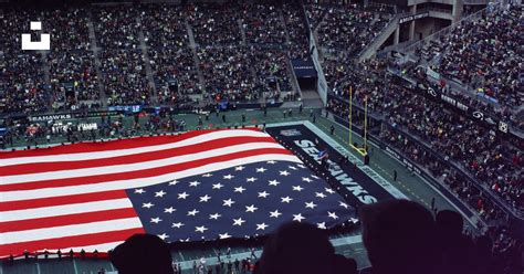 A large american flag is displayed in a stadium photo – Free Analogue photography Image on Unsplash