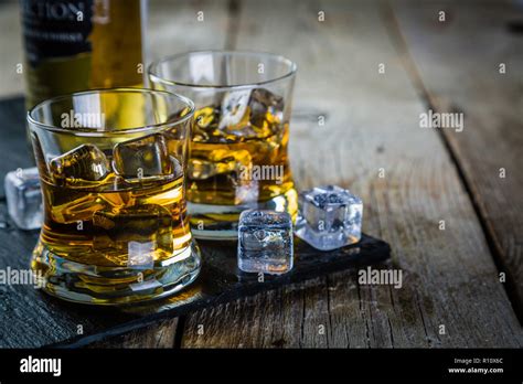 Whiskey with ice in glasses Stock Photo - Alamy