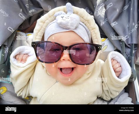 Funny face of baby girl is laughing in sunglasses. Cute baby with sunglasses Stock Photo - Alamy