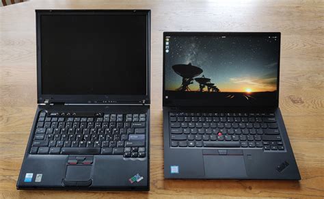 My dad's old IBM ThinkPad T40 next to my new Lenovo Thinkpad X1 Carbon : thinkpad