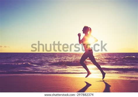 Woman Running On Beach Sunset Stock Photo (Edit Now) 297882374