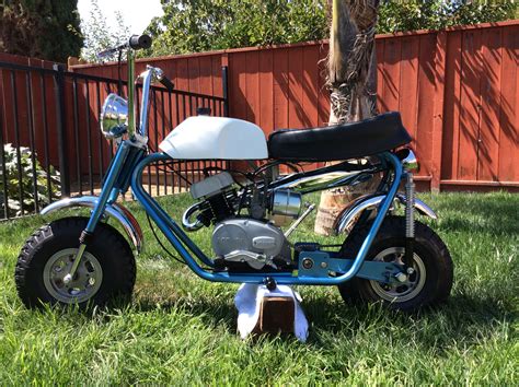 a small motorcycle is parked in the grass