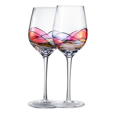 two wine glasses with different colored designs on them