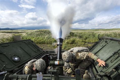 Mortar Blast. Soldiers use a 120 mm mortar system on an M1129 mortar carrier during a live-fire ...