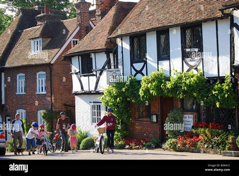 Family on bicycles, Chilham Square, Chilham, Kent, England, United ...